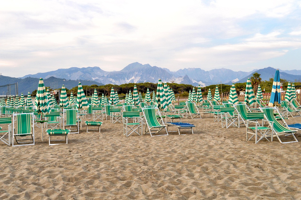 Spiaggia sabbiosa dell'Abruzzo con mare cristallino e scogliere sullo sfondo.