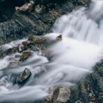 Cascata nascosta in Abruzzo, immersa nella natura, con acqua che scorre tra le rocce.